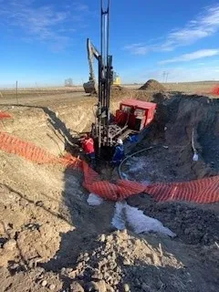 Drill rig working in an excavation for environmental drilling